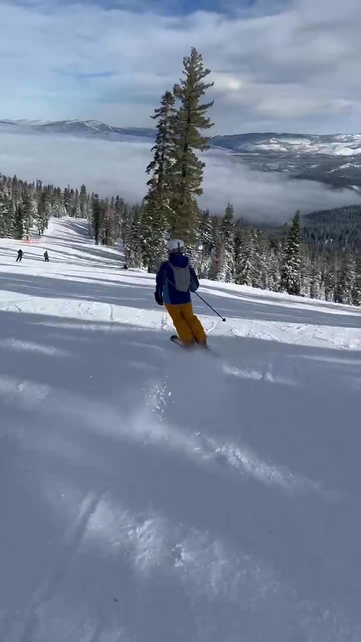 Kid skier moving across the slope
